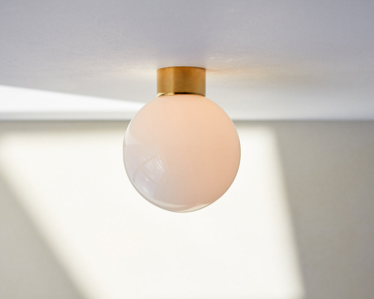 Aura Globe Glass Wall Sconce in Brass for Modern Interiors
