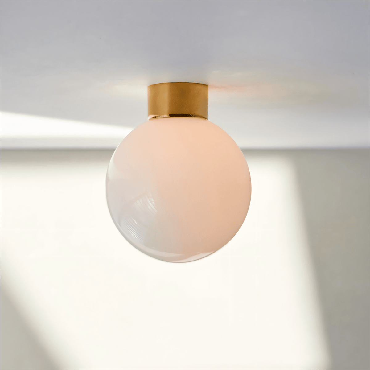 Aura Globe Glass Wall Sconce in Brass for Modern Interiors