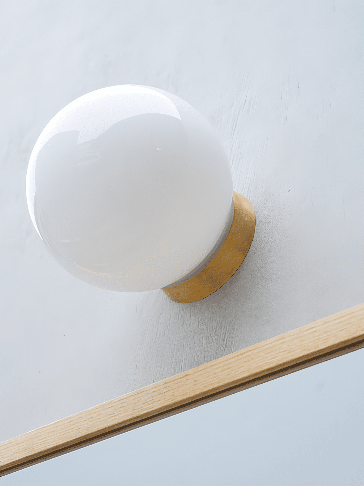 Aura Globe Glass Wall Sconce in Brass for Modern Interiors