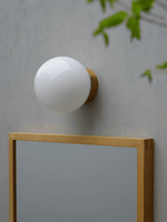 Aura Globe Glass Wall Sconce in Brass for Modern Interiors