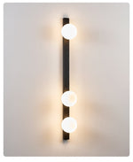 Balanced Globe Wall Sconce in Black Travertine and Opal Glass