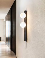 Balanced Globe Wall Sconce in Black Travertine and Opal Glass