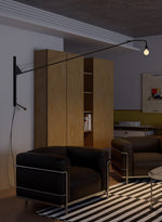 Modern Swing Arm Wall Sconce with Extended Reach in Matte Black