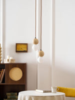 Camille Travertine Pendant Light – Natural Stone Sphere with Opal Glass Globe