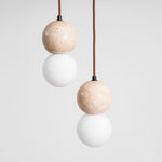 Camille Travertine Pendant Light – Natural Stone Sphere with Opal Glass Globe