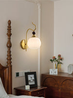 Celeste Curved Wall Sconce in Gold or Black with Pleated Glass Shade