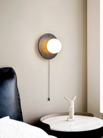 Crater Backlit Wall Sconce in Black Travertine with Opal Glass Globe