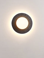 Crater Backlit Wall Sconce in Black Travertine with Opal Glass Globe