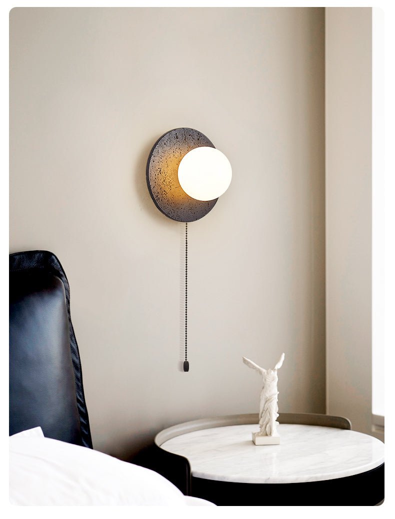 Crater Backlit Wall Sconce in Black Travertine with Opal Glass Globe