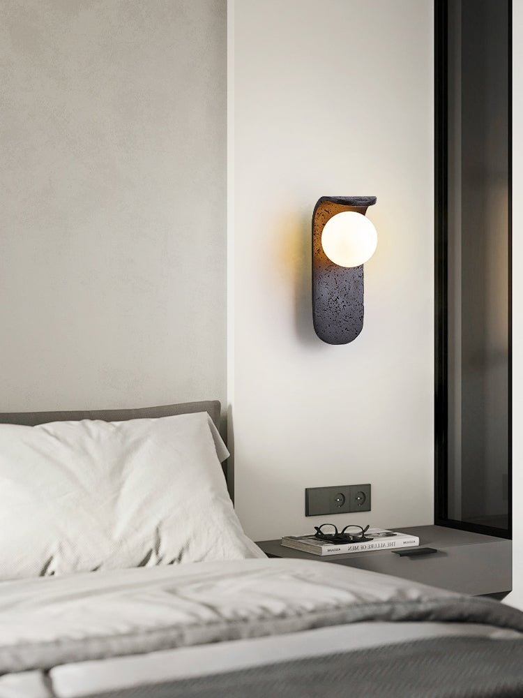 Eclipse Orb Wall Sconce in Black Travertine with Opal Glass Shade
