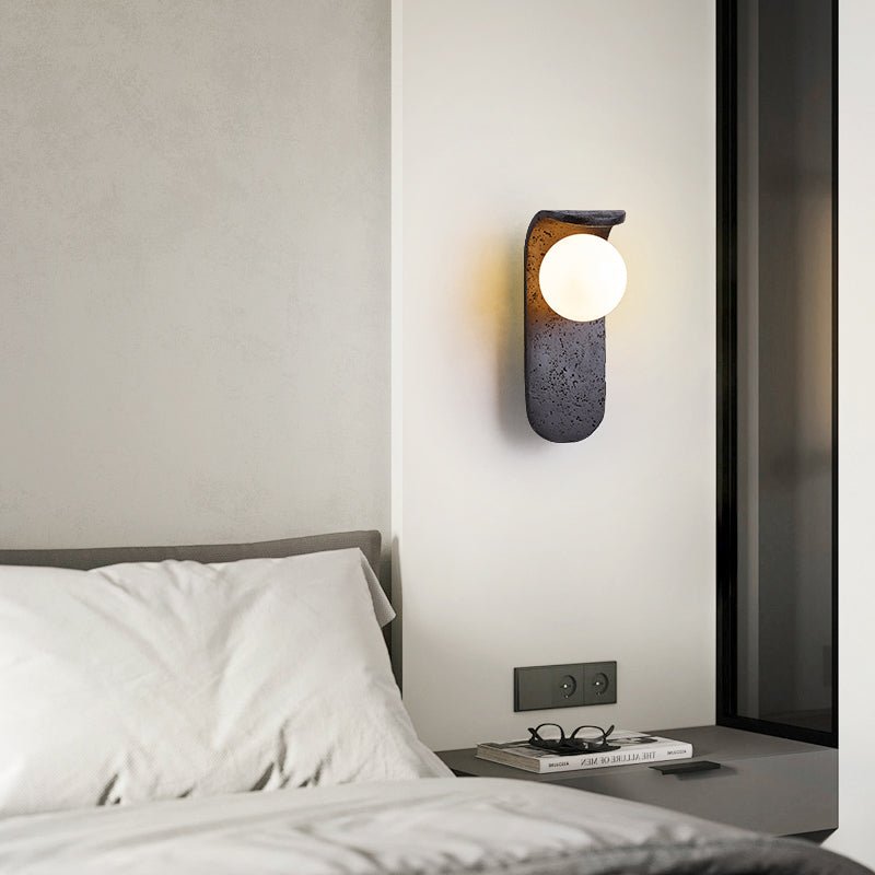 Eclipse Orb Wall Sconce in Black Travertine with Opal Glass Shade