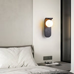 Eclipse Orb Wall Sconce in Black Travertine with Opal Glass Shade