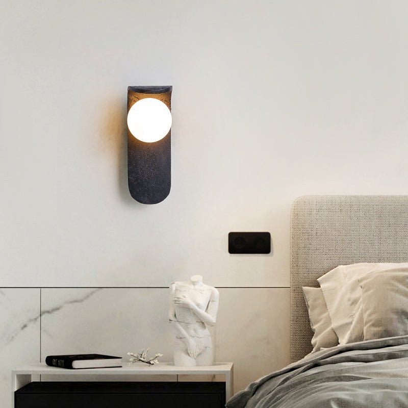 Eclipse Orb Wall Sconce in Black Travertine with Opal Glass Shade