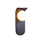 Eclipse Orb Wall Sconce in Black Travertine with Opal Glass Shade