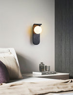 Eclipse Orb Wall Sconce in Black Travertine with Opal Glass Shade