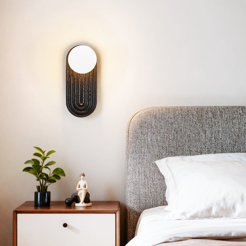 Eventide Orb Wall Sconce in Black Travertine with Opal Glass Globe