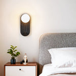 Eventide Orb Wall Sconce in Black Travertine with Opal Glass Globe
