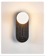Eventide Orb Wall Sconce in Black Travertine with Opal Glass Globe
