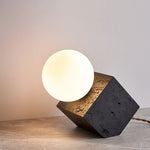 Kryden Sculptural Table Lamp in Black Travertine with Glass Globe