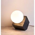 Kryden Sculptural Table Lamp in Black Travertine with Glass Globe
