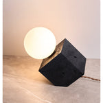 Kryden Sculptural Table Lamp in Black Travertine with Glass Globe