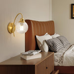 Lucienne Curved Wall Sconce in Gold with Clear Glass Globe