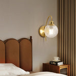 Lucienne Curved Wall Sconce in Gold with Clear Glass Globe