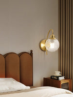 Lucienne Curved Wall Sconce in Gold with Clear Glass Globe