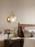 Lucienne Curved Wall Sconce in Gold with Clear Glass Globe