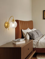 Lucienne Curved Wall Sconce in Gold with Clear Glass Globe