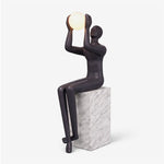 Sculptural Matte Black Floor Lamp with Marble Base and Glowing Orb