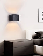 Lumina Void Sconce — Black Travertine Wall Light with Warm Glow