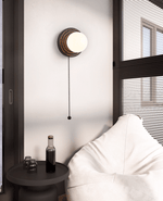 Lunara Black Travertine Wall Sconce with Opal Glass Globe