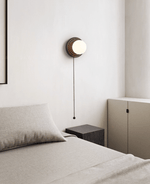 Lunara Black Travertine Wall Sconce with Opal Glass Globe