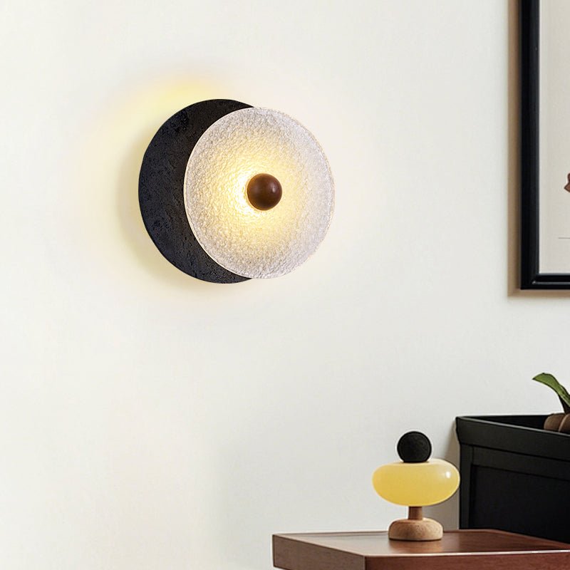 Lunara Textured Disc Wall Sconce in Black Travertine and Frosted Glass