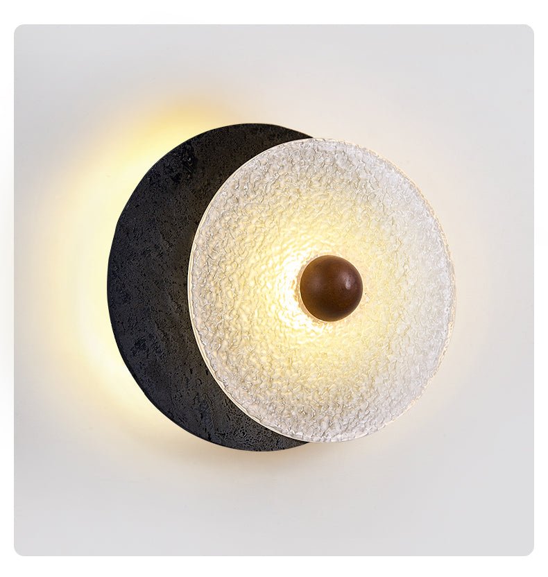 Lunara Textured Disc Wall Sconce in Black Travertine and Frosted Glass