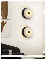 Lunara Textured Disc Wall Sconce in Black Travertine and Frosted Glass
