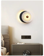Lunara Textured Disc Wall Sconce in Black Travertine and Frosted Glass