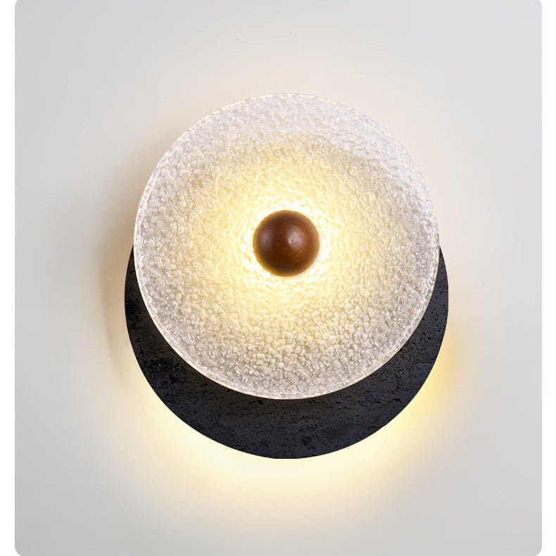 Lunara Textured Disc Wall Sconce in Black Travertine and Frosted Glass