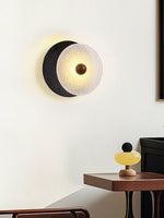 Lunara Textured Disc Wall Sconce in Black Travertine and Frosted Glass