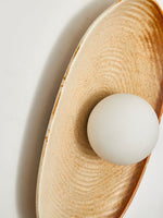 Solstice Swirl Ceramic Wall Sconce with Glowing Orb