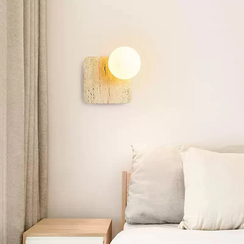Travora Globe Wall Sconce in Natural Travertine with Opal Glass Shade