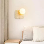 Travora Globe Wall Sconce in Natural Travertine with Opal Glass Shade