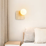 Travora Globe Wall Sconce in Natural Travertine with Opal Glass Shade