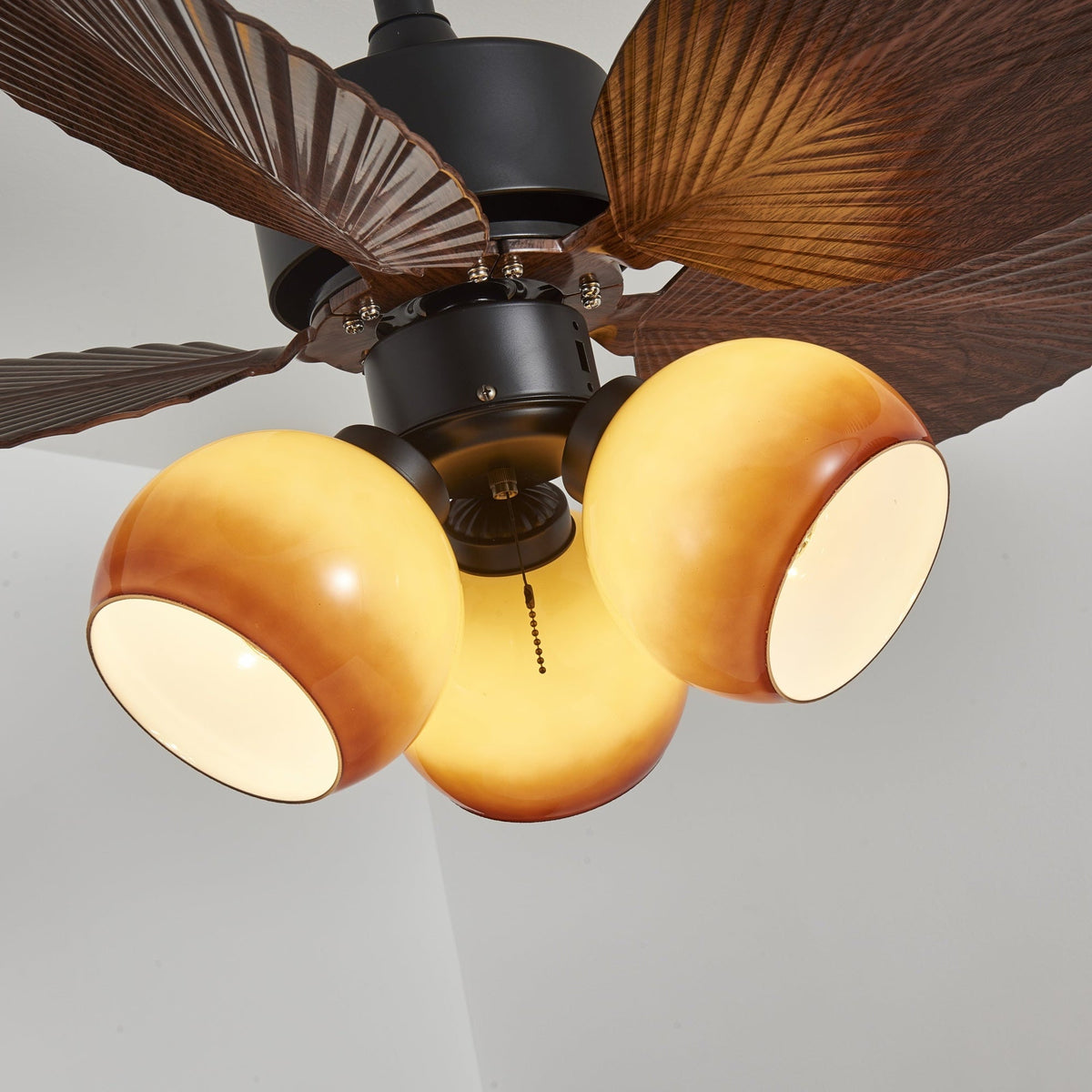 Tropiluxe Ceiling Fan Light with Palm Leaf Blades and Amber Glass Shade