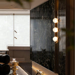 Vertical Balls Bar Wall Sconce in Gold with Clear Glass Globes