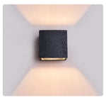 Vulcanis Cube Wall Sconce in Black Travertine with Golden Interior