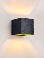 Vulcanis Cube Wall Sconce in Black Travertine with Golden Interior