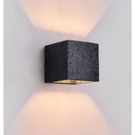 Vulcanis Cube Wall Sconce in Black Travertine with Golden Interior