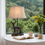 Sculpted Deer Table Lamp with Bronze Finish and Beige Linen Shade